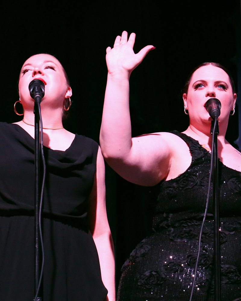Emma and Melissa singing backing vocals on stage