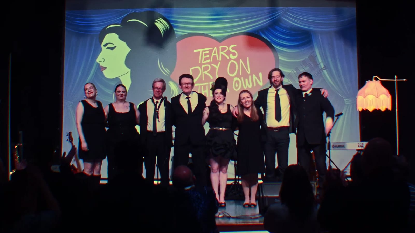 The full cast and band taking a bow at the end of the show
